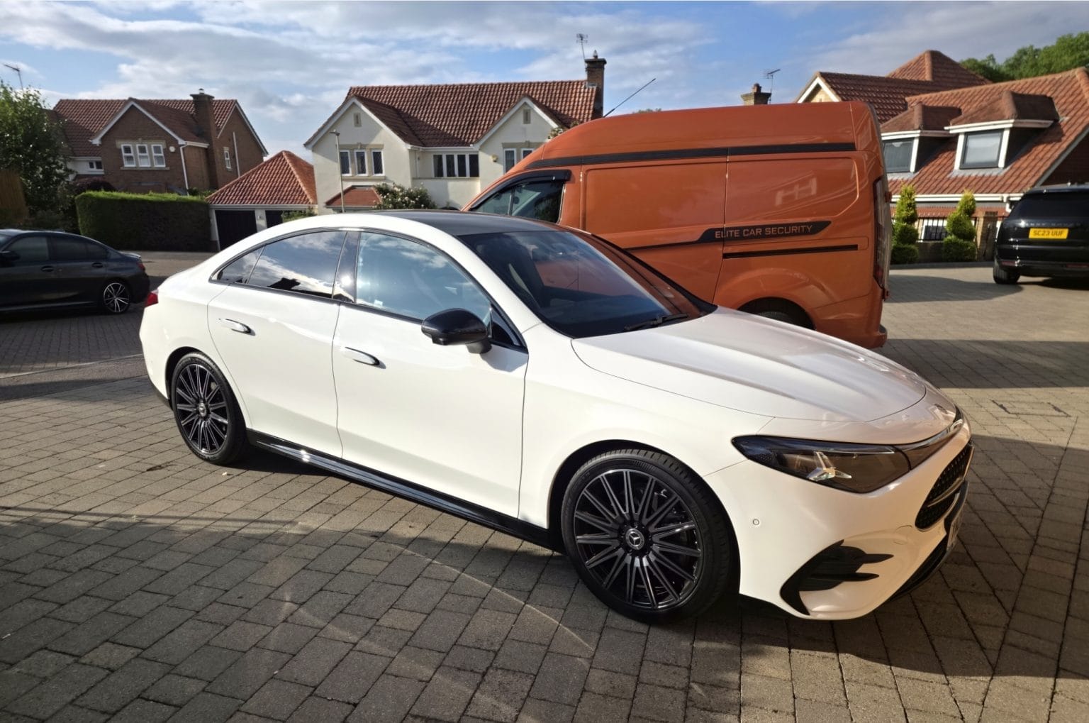 White Mercedes CLA secured by Elite Car Security with the branded orange van in the background